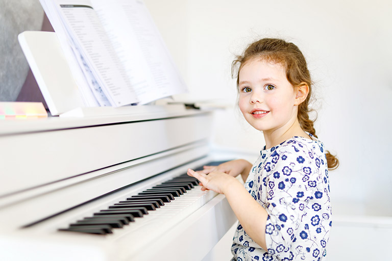 child plays piano